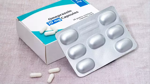 Blister packs of omeprazole tablets used for acid reflux and heartburn treatment.