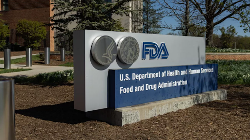 Exterior view of the U.S. Food and Drug Administration (FDA) headquarters sign outside a building, representing the agency’s decision to reverse long-standing hormone therapy guidelines for menopause.