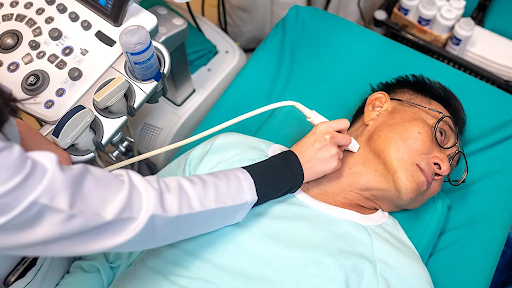 A doctor checking a patient for thyroid cancer